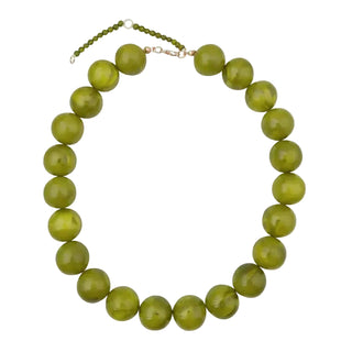 Green beaded necklace on a white background