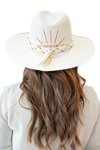 Baldiz Hook Em Game Day Hat. Natural straw hat with embroidered 'HOOK EM' sunburst design and cream rope band with tassels