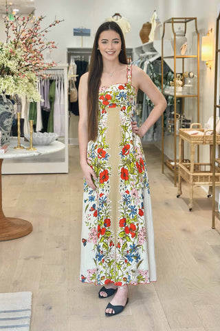 Woman wearing a floral dress in a store setting