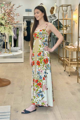 Woman wearing a floral dress in a store setting