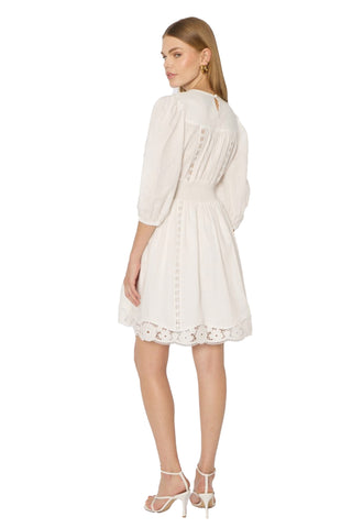 Berenice Roodie Court Dress. White English embroidered mini dress with V-neckline, cinched waist, and long sleeves with elastic cuffs