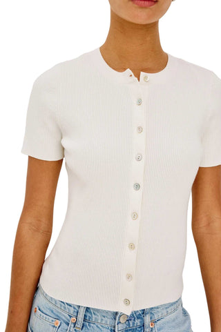 White ribbed knit button-up shirt worn by a person on a white background