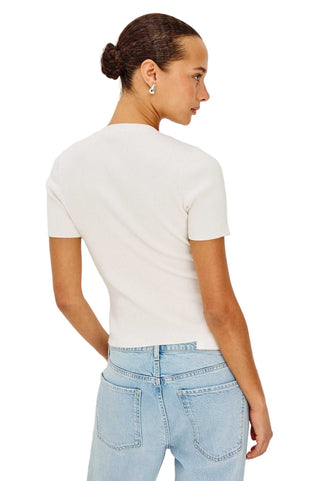 Person wearing a white t-shirt and light blue jeans on a plain background