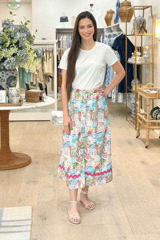 Woman wearing a white t-shirt and colorful skirt in a store setting