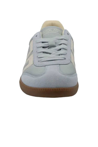 Light blue sneaker with brown sole on a white background
