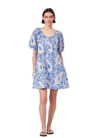 blue and white paisley print mini dress with puff sleeves, scoop neckline, and button front closure. Livro Day Dress in Steel Paisley