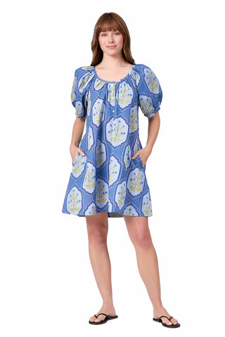 blue mini dress with white botanical medallion pattern, featuring puff sleeves, scoop neckline, and button front closure with pockets. Livro Day Dress in Dusty Trellis