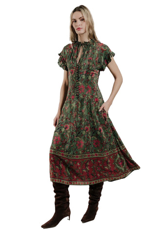 Love the Label Florentine Dress. Green and red floral print midi dress with gathered neckline, flutter sleeves, and tiered skirt worn