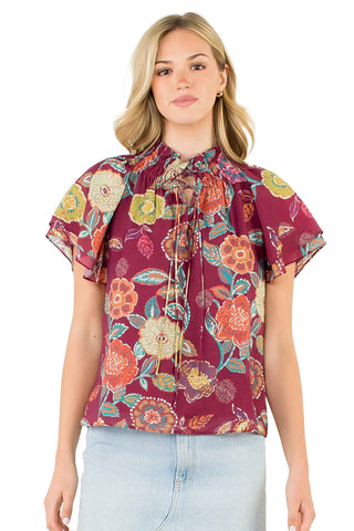 burgundy floral print blouse with tie-neck detail and flutter sleeves