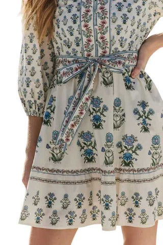 Person wearing a floral dress with a blurred background