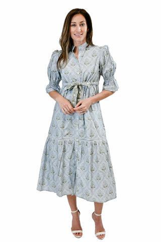 Victoria Dunn Maxi Dress in Frosted Ember. Light blue maxi dress with small floral print featuring puff sleeves, waist tie, and tiered ruffle hem