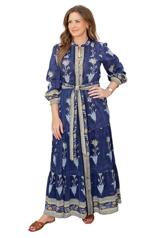 Salrosa Lia maxi dress in navy black with white tulip print featuring long sleeves, tiered hem, gold trim details and tie belt for elegant occasions