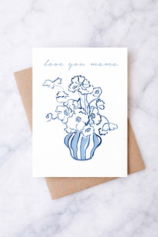 Greeting card with floral design and 'love you mom' text on a marble surface. Mother's Day Card