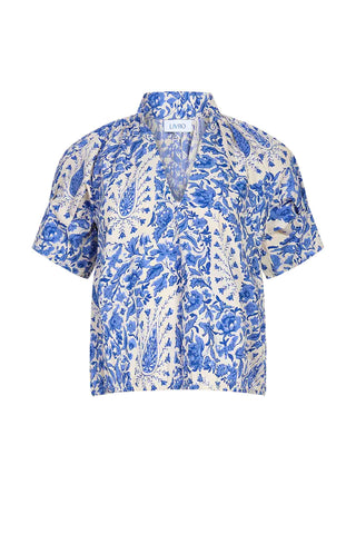 Blue and white paisley print short sleeve blouse with collar and button front closure. Livro Merritt Top in Steel Paisley