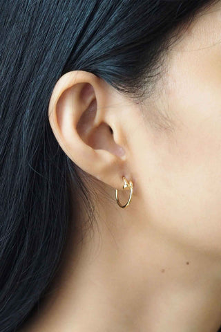 Tai Jewelry Nail Hoop in Gold. Small gold hoop earrings worn in ear with modern spike or nail detail accent on delicate circular hoop