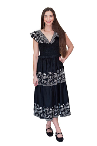 Moon River Nicole V-Neck Ruffle Sleeve Midi Dress in Black. Black midi dress with white floral embroidery, V-neck, ruffle sleeves, smocked waist, and tiered skirt