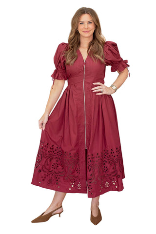 Entro Olivia dress in garnet red featuring dramatic puff sleeves with tie details, front zip closure and intricate eyelet embroidery at midi hem