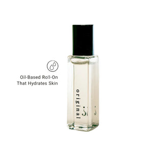 Oil-based roll-on bottle with black cap on a light gray background