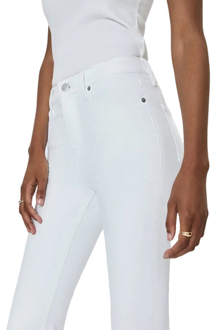 Person wearing white jeans on a plain background