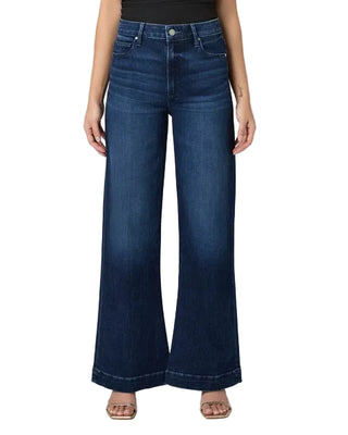 Person wearing blue wide-leg jeans on a plain background