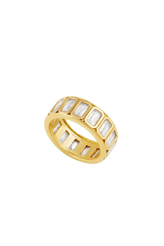 Wide gold band ring featuring multiple emerald-cut clear crystals set flush around the circumference in a continuous row