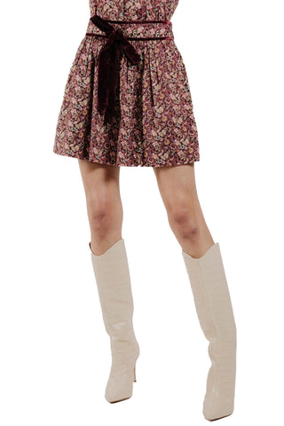 Love the Label Rosie Skirt in Pippa Symphony. urgundy and pink floral print mini skirt with gathered waist, velvet tie belt, and flowing silhouette