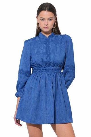 Adelyn Rae Salome mini dress in cobalt blue featuring high collar, intricate lace details, long sleeves and smocked waist with gathered skirt