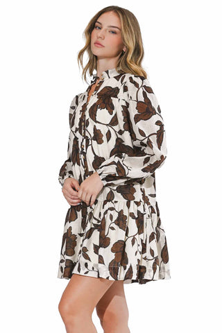 Adelyn Rae Sharon Long Sleeve Cotton Dress. cream cotton mini dress with brown floral print, long sleeves, button front closure, and tiered ruffle hem