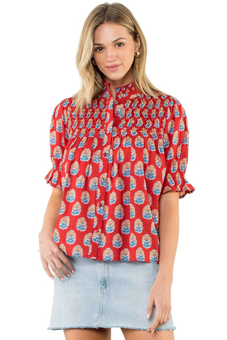 THML Short Sleeve Button up Top in Red. Red button-up blouse with blue and orange medallion print, featuring mock neckline, ruffle short sleeves, and relaxed fit