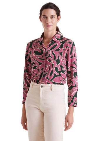 The Josephine top featuring bold pink and green abstract swirl print with button-front closure, tailored collar and long sleeves for statement fashion
