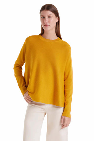 The Maria sweater in bright yellow featuring crew neck design, long sleeves and relaxed fit knit construction for comfortable colorful layering