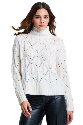 Lisa Todd The Standout Sweater in Winter White. Winter white cable-knit turtleneck sweater with openwork zigzag pattern, high ribbed neck, and colorblock cuffs