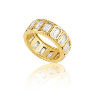 Gold ring with rectangular gemstones on a white background