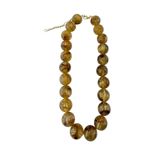 A beaded necklace made of polished round brown gemstone beads with a gold-tone clasp, shown on a plain white background.