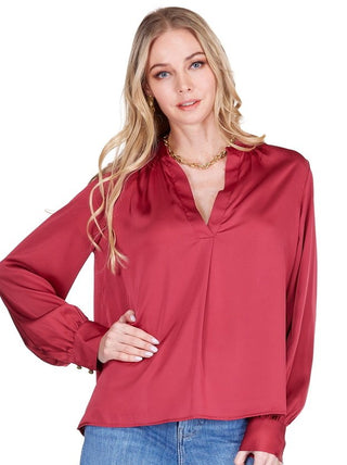 Joy Joy placket V-neck top in burgundy featuring flowing silky fabric, V-neckline with placket detail and blouson sleeves with fitted cuffs