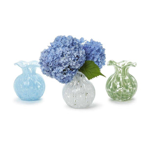 Three small decorative vases with a bouquet of blue flowers on a white background